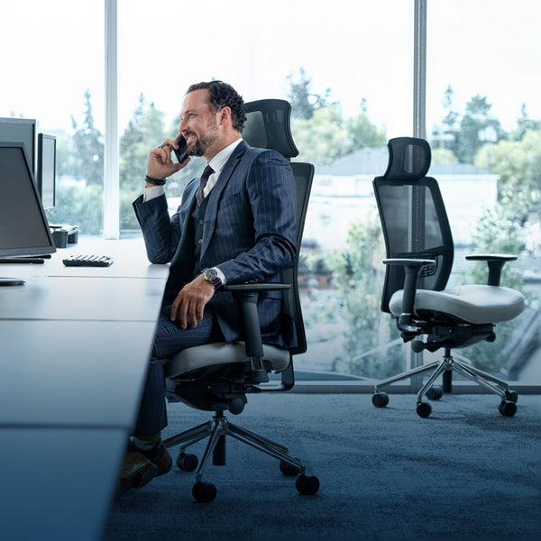 This is an image of a Lifeform© Chairs Mesh Back Chair in an office with a person sitting in it